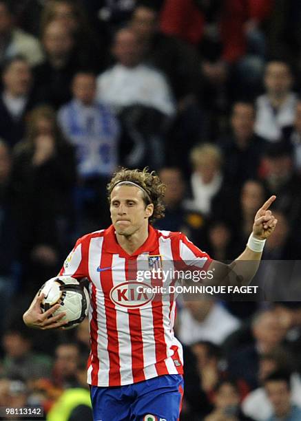 Atletico Madrid's Uruguayan forward Diego Forlan reacts after scoring during the Spanish league football match Real Madrid against Atletico Madrid at...