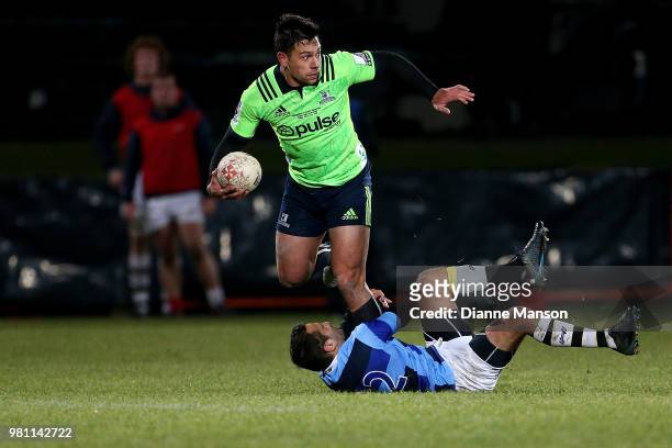 Rob Thompson of the Highlanders is tackled by Alexis Bales of the French Barbarians during the match between the Highlanders and the French...