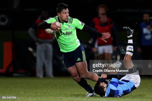 Rob Thompson of the Highlanders is tackled by Alexis Bales of the French Barbarians during the match between the Highlanders and the French...