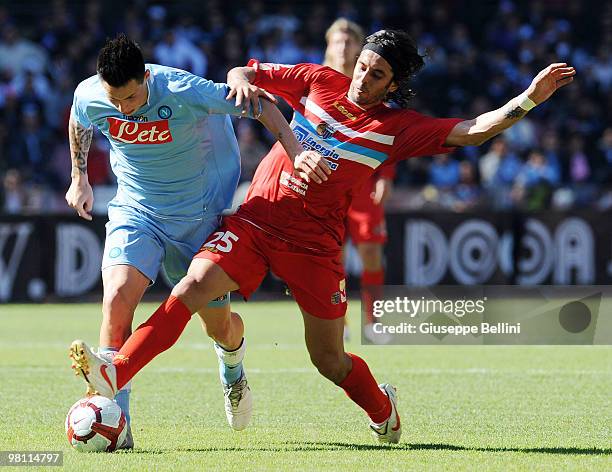 Marek Hamsik of Napoli and Jorge Martinez of Catania in action during the Serie A match between SSC Napoli and Catania Calcio at Stadio San Paolo on...