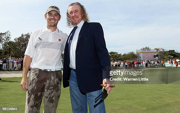Louis Oosthuizen of South Africa poses with Miguel Angel Jimenez of Spain after winning the Open de Andalucia 2010 on a score of -17 under par at...