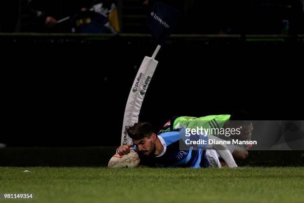 Hugo Bonneval of the French Babarians dives over to score a try in the tackle of Tevita Li of the Highlanders during the match between the...