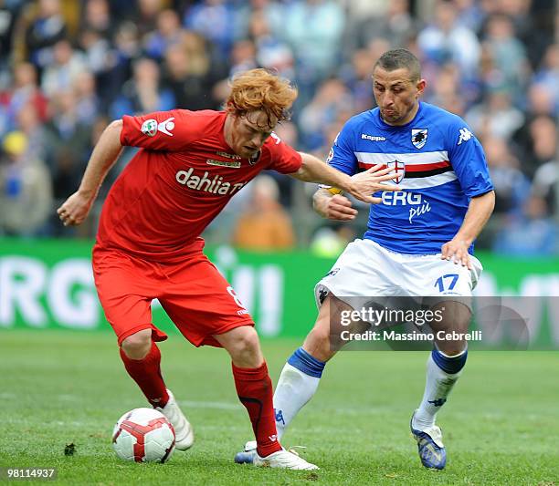 Davide Biondini of Cagliari Calcio battles for the ball against Angelo Palombo of UC Sampdoria during the Serie A match between UC Sampdoria and...