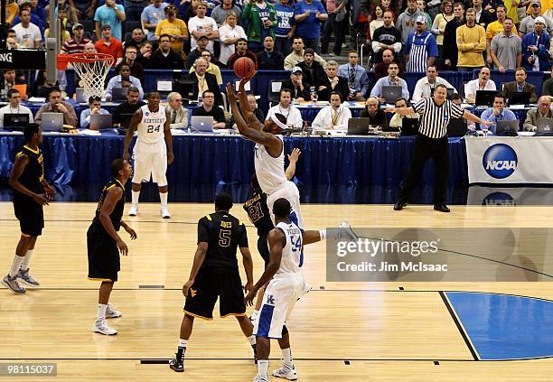 DeMarcus Cousins of the Kentucky Wildcats attempts a shot against Joe Mazzulla of the West Virginia Mountaineers during the east regional final of...