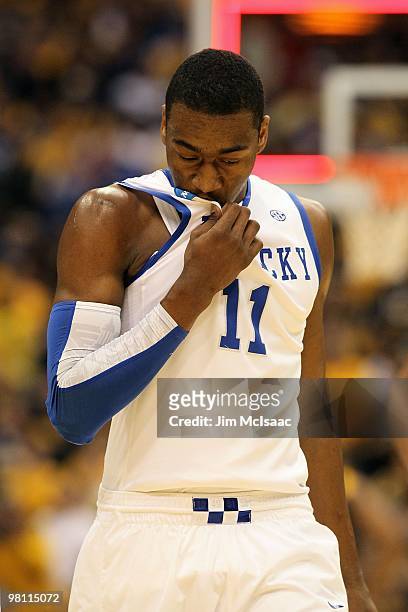 John Wall of the Kentucky Wildcats wipes his face with his jersey against the West Virginia Mountaineers during the east regional final of the 2010...