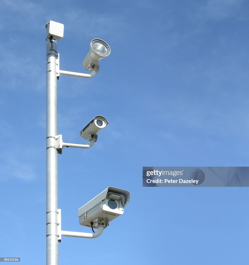 CCTV cameras against blue sky