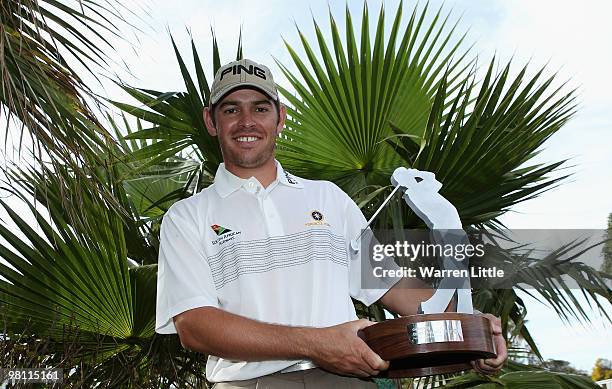 Louis Oosthuizen of South Africa poses with the trophy after winning the Open de Andalucia 2010 on a score of -17 under par at Parador de Malaga Golf...