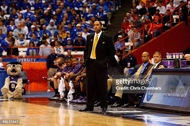 Head coach Lorenzo Romar of the Washington Huskies looks on as he coaches against the West Virginia Mountaineers during the east regional semifinal...