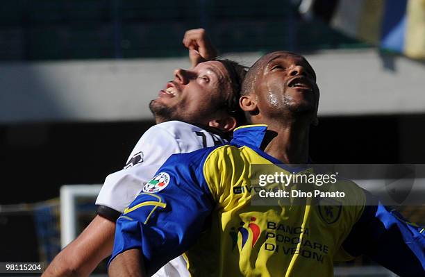 Marcos De Paula of Chievo competes with Christian Zaccardo of Parma during the Serie A match between AC Chievo Verona and Parma FC at Stadio...