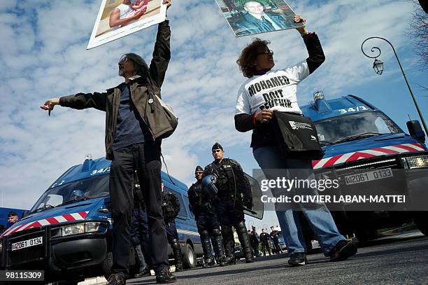 Quelques manifestants brandissent des posters de personnes expulsées lors d'un rassemblement le 29 mars 2010 à l'appel d'une quinzaine d'associations...