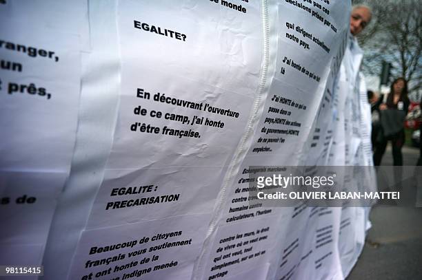 Quelques manifestants déploient un drap blanc avec des messages écrits à destination des retenus du centre de rétention administrative du...