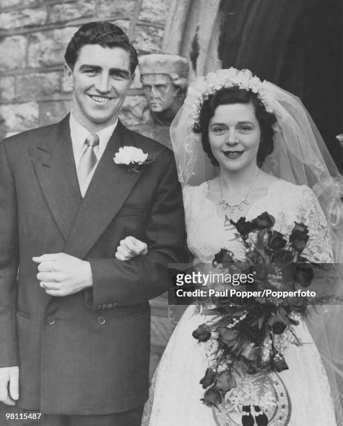 English footballer Bobby Smith, of Chelsea FC, with Mavis Peachey after their wedding at St Thomas's Church, Fulham, London, 27th February 1954.