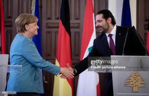 June 2018, Lebanon, Beirut: German Chancellor Angela Merkel and Saad Rafiq Hariri, PM of Lebanon, shaking hands after a press conference. Lebanon is...