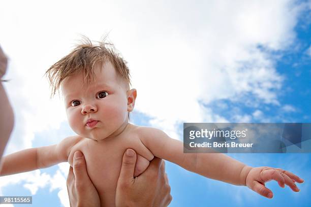 mother holding baby up in the air - pretending to be a plane stock pictures, royalty-free photos & images
