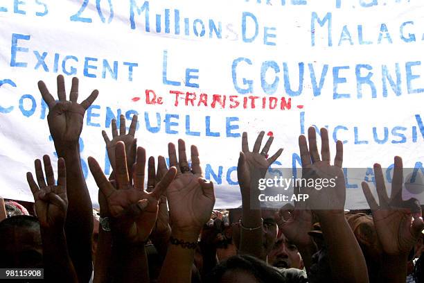 Opposition supporters hold their arms up as they try to break a police barricade on Mach 29, 2010 during the commemorations of the national uprising...