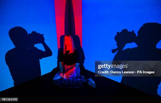 Shadows from a photographer are pictured next to Hanna Chapman as she looks at an installation titled Totem by Internationally renowned Dutch artist...