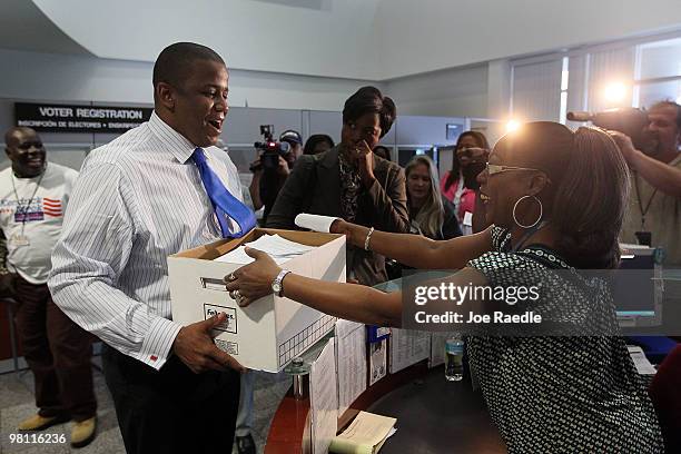 Democratic Senate candidate Kendrick Meek hands a box of voter petitions to Melinda Noble at the Miami-Dade Supervisor of Elections office on March...