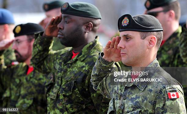 Canadian soldiers, members of the NATO mission in Bosnia and Herzegovina stand to attention for the unveiling of a memorial plaque during the...