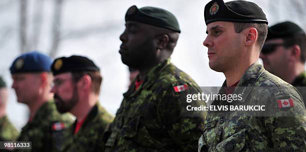 Canadian soldiers, members of the NATO mission in Bosnia and Herzegovina stand for the unveiling of a memorial plaque during the Canadian mission...