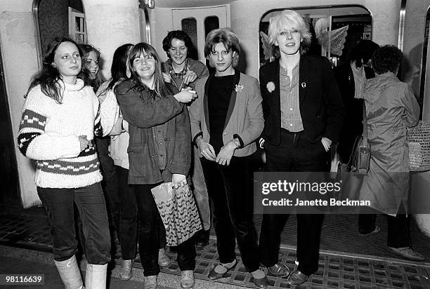 British musicians Mick Karn and David Sylvian of the British pop group Japan pose several unidentified female fans, London, England, late 1970s.