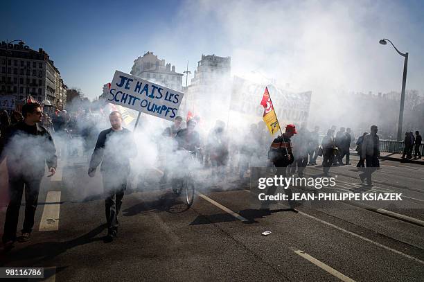 People demonstrate on March 23, 2010 in Lyon, as part of a nationwide day of protest against job cuts, wages, the high cost of living and plans for...