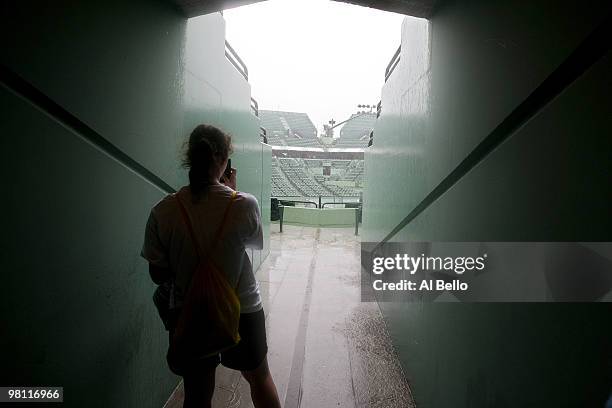 Spectator takes a photo of the rain during day seven of the 2010 Sony Ericsson Open at Crandon Park Tennis Center on March 29, 2010 in Key Biscayne,...