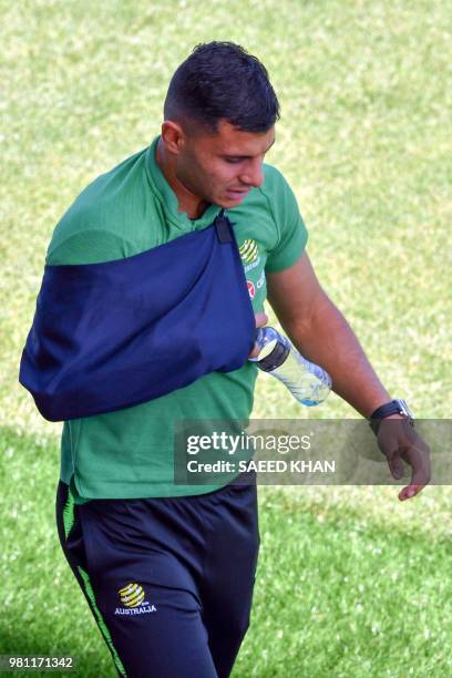 Injured Australia's forward Andrew Nabbout walks back from the football field after a training session in Kazan on June 22 during the Russia 2018...