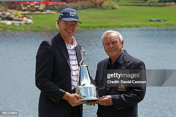 Ernie Els of South Africa is presented with the trophy by host Arnold Palmer of the USA after the completion of the final round of the Arnold Palmer...