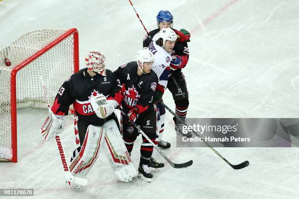 Karl Stollery of Canada and Zenon Konopka of USA compete in the goal area during the Ice Hockey Classic between the United States of America and...