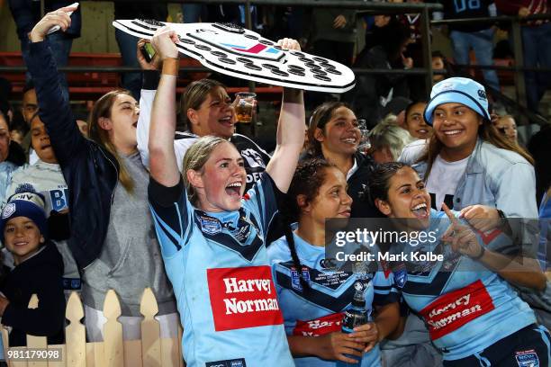 Maddison Studdon of the Blues holds the shield as she celebrates victory with the crowd during the Women's State of Origin match between New South...