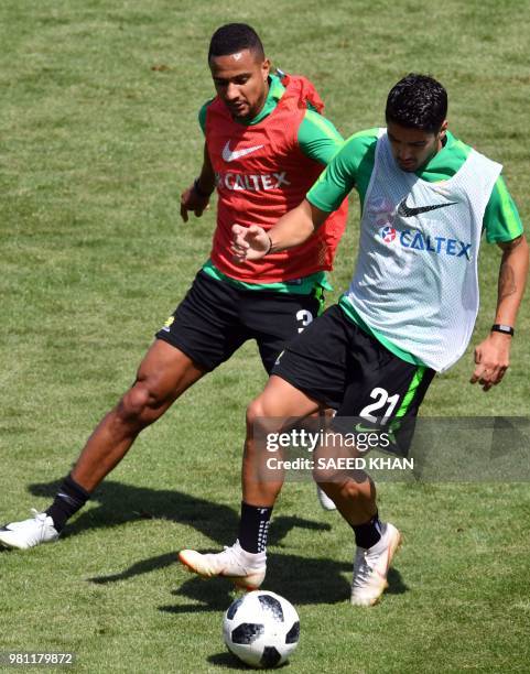 Australia's forward Dimitri Petratos and defender James Meredith take part in a training session of Australia national team in Kazan on June 22...