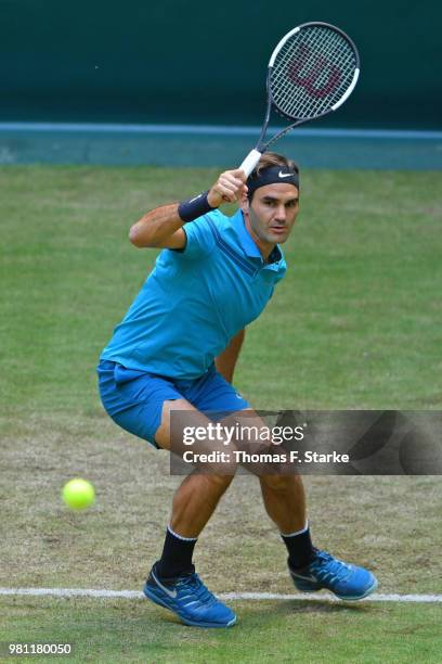 Roger Federer of Switzerland plays a backhand in his match against Matthew Ebden of Australia during day five of the Gerry Weber Open at Gerry Weber...