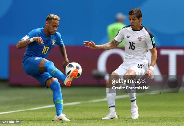 Neymar Jr is challenged by Cristian Gamboa of Costa Rica during the 2018 FIFA World Cup Russia group E match between Brazil and Costa Rica at Saint...