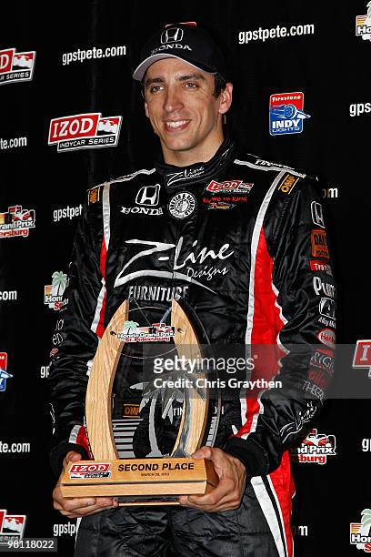 Justin Wilson of England, driver of the Team Z-Line Designs Dreyer & Reinbold Racing Dallara Honda celebrates with the second place trophy after the...