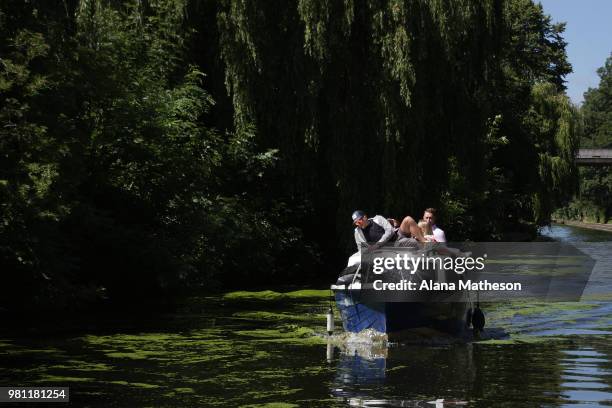 Boat makes its way along Regent's Canal on June 22, 2018 in London, England. Much of the UK is expected to enjoy seasonable weather this weekend with...