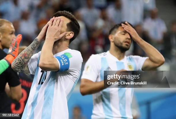 Lionel Messi and team mate Sergio Aguero of Argentina show their dejection during the 2018 FIFA World Cup Russia group D match between Argentina and...