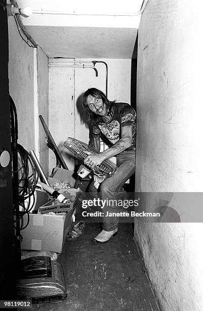 British musician Dave Brock of the rock band Hawklords grips a floor fan, a crazed expression on his face, England, 1978.