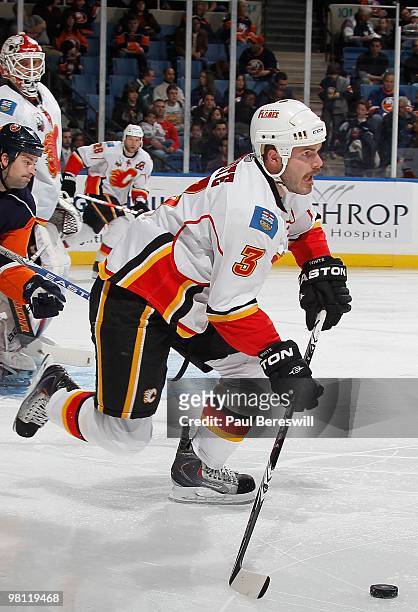 Defenseman Ian White of the Calgary Flames skates with the puck against the New York Islanders during an NHL game at the Nassau Coliseum on March 25,...