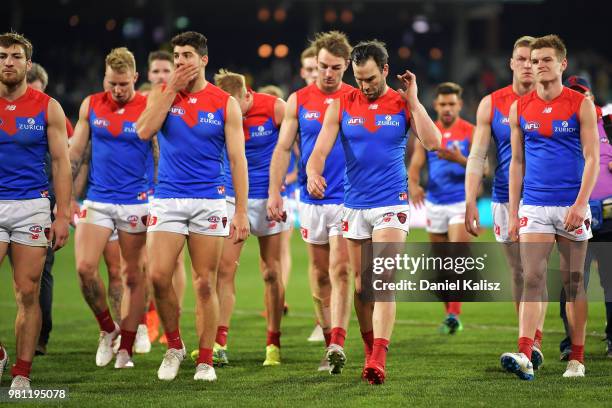 Melbourne Deamons players walk from the field looking dejected after the round 14 AFL match between the Port Adelaide Power and the Melbourne Demons...