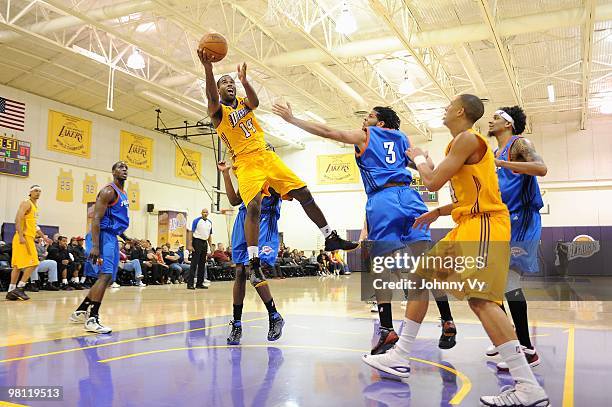 Joe Crawford of the Los Angeles D-Fenders lays the ball up over Rodney Webb of the Tulsa 66ers during the D-League game on February 10, 2010 at...