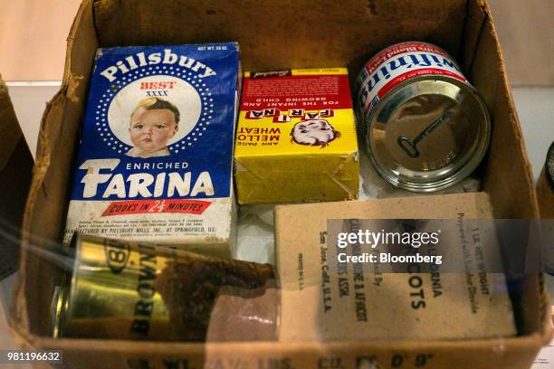 Boxes and tins of food sit inside a World War II era Cooperative for Assistance and Relief Everywhere package at the Allied Museum in Berlin,...