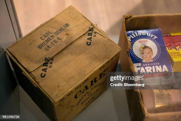 Boxes and tins of food sit inside a World War II era Cooperative for Assistance and Relief Everywhere package at the Allied Museum in Berlin,...