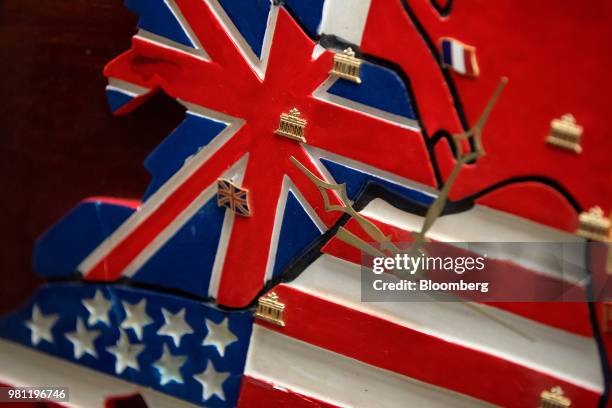 The U.S., France, United Kingdom and Russian Soviet Union national flags divide a Berlin map-shaped wall clock commemorating the activities of the...