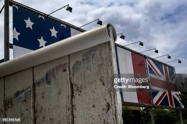 Section of the Berlin wall stands on display in front of U.S., France and United Kingdom national flags at the Allied Museum in Berlin, Germany, on...