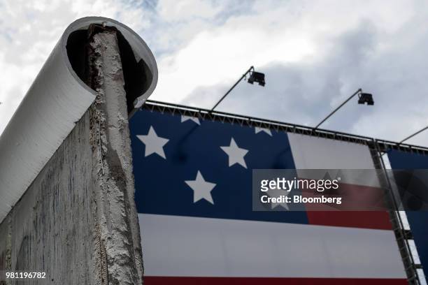 The U.S. National flag sits on display beyond a section of the Berlin wall at the Allied Museum in Berlin, Germany, on Friday, June 15, 2018....