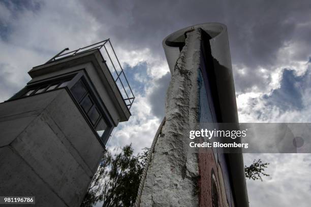 Watchtower building stands beside a section of the Berlin wall at the Allied Museum in Berlin, Germany, on Friday, June 15, 2018. Visitors to the...