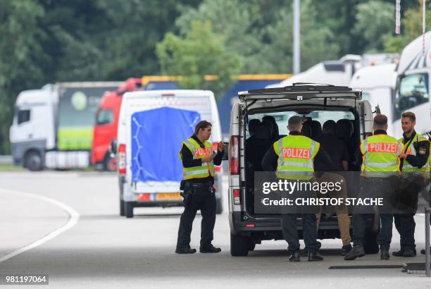 German police officers control a van at a control point at the border between Austria and Germany near the Bavarian village of Kiefersfelden,...