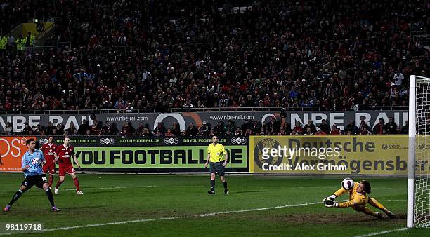 Goalkeeper Tobias Sippel of Kaiserslautern parries a penalty by Alexander Ludwig of Muenchen during the Second Bundesliga match between 1. FC...