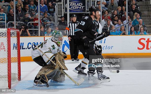 Marty Turco of the Dallas Stars looks for the puck against Joe Thornton of the San Jose Sharks during an NHL game on March 25, 2010 at HP Pavilion at...