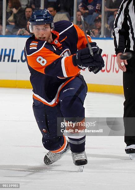 Defenseman Bruno Gervais of the New York Islanders shoot the puck into the Calgary zone during an NHL game against the Calgary Flames at the Nassau...